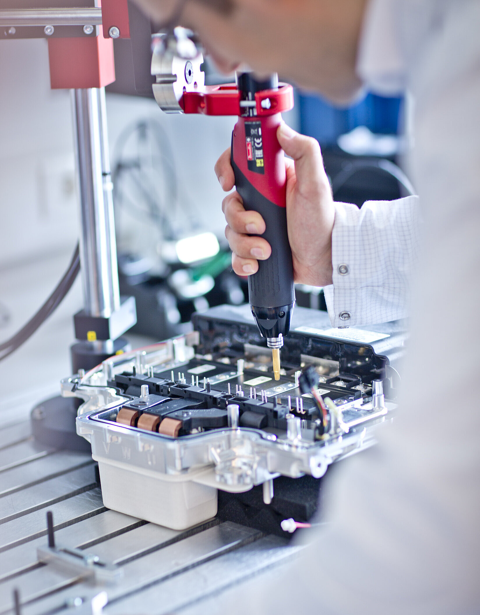 Electric screwdriver used for assembling an electronic unit.