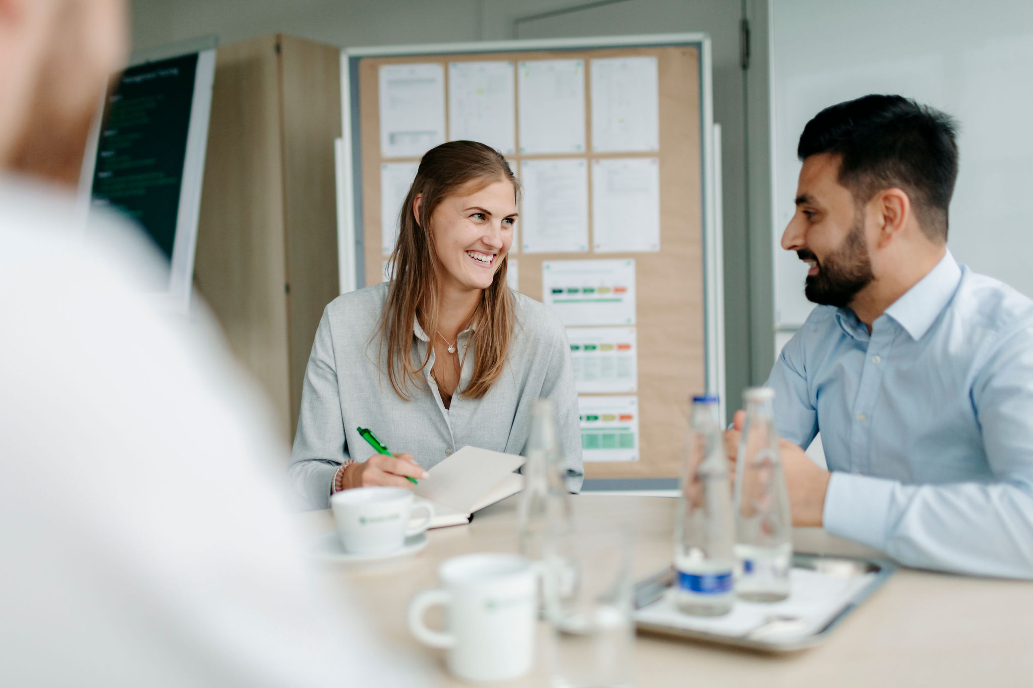 Two Silver Atena employees engaged in a technical discussion during a project meeting.